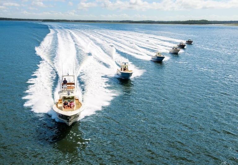 six speed boats racing in the water