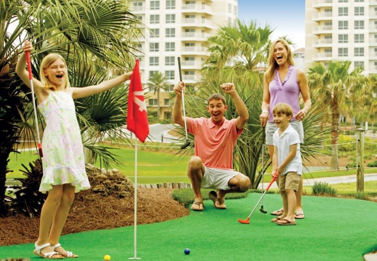 Family playing mini putt