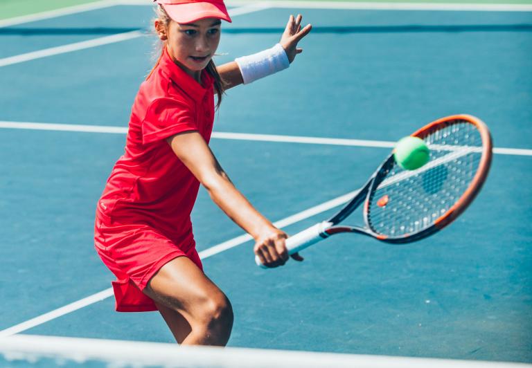 girl playing tennis